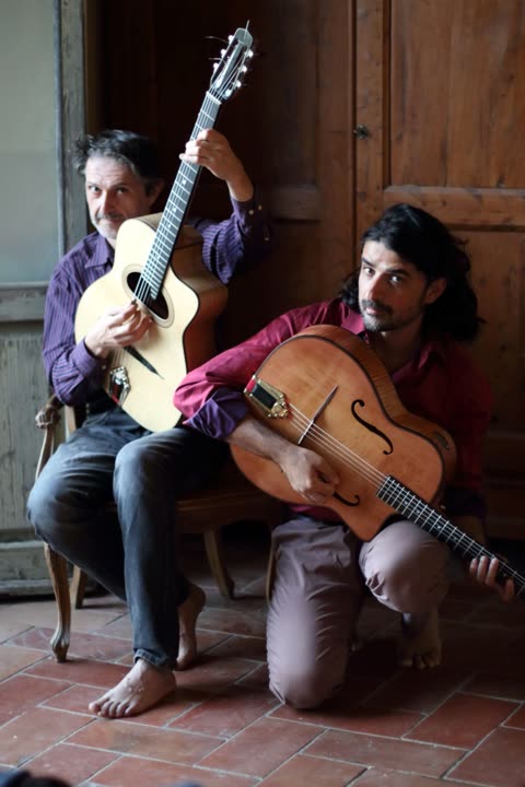 Stefano Bartalesi and Lorenzo Spini posing with their gypsy jazz guitars